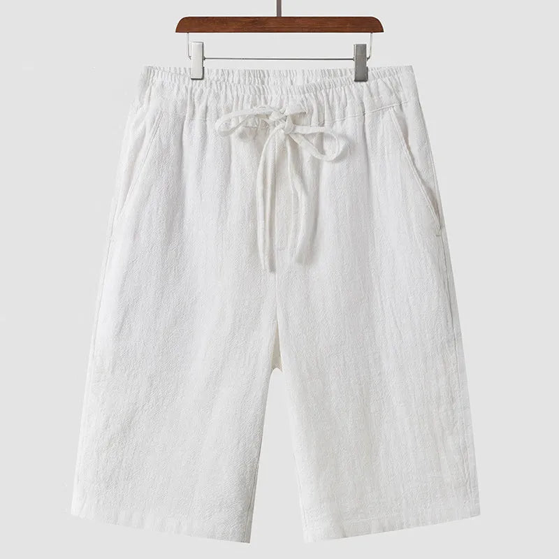 Men's linen shorts in loose cropped style with elastic waistband in various colours