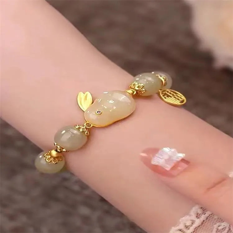 Green lucky bracelet with fu character charm, jade hare charm, and black bracelet base