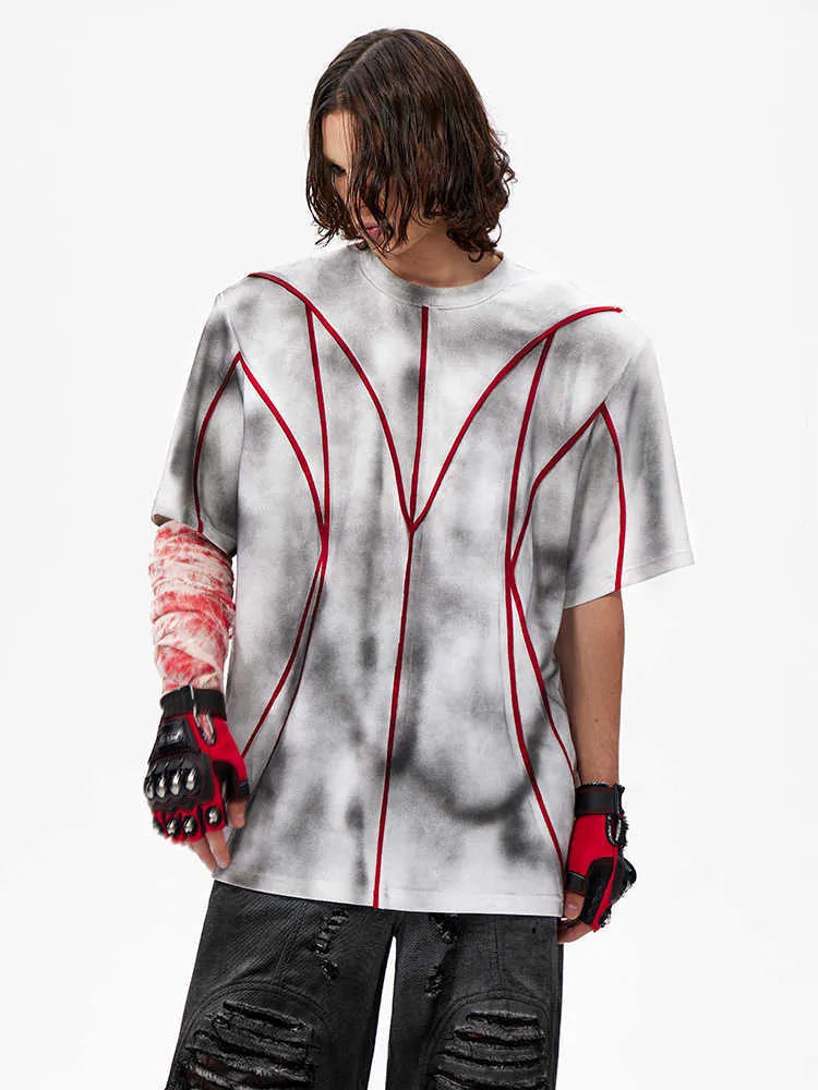 Women's short sleeve T-shirt with padded shoulders and textured line patchwork detail on a round neck.