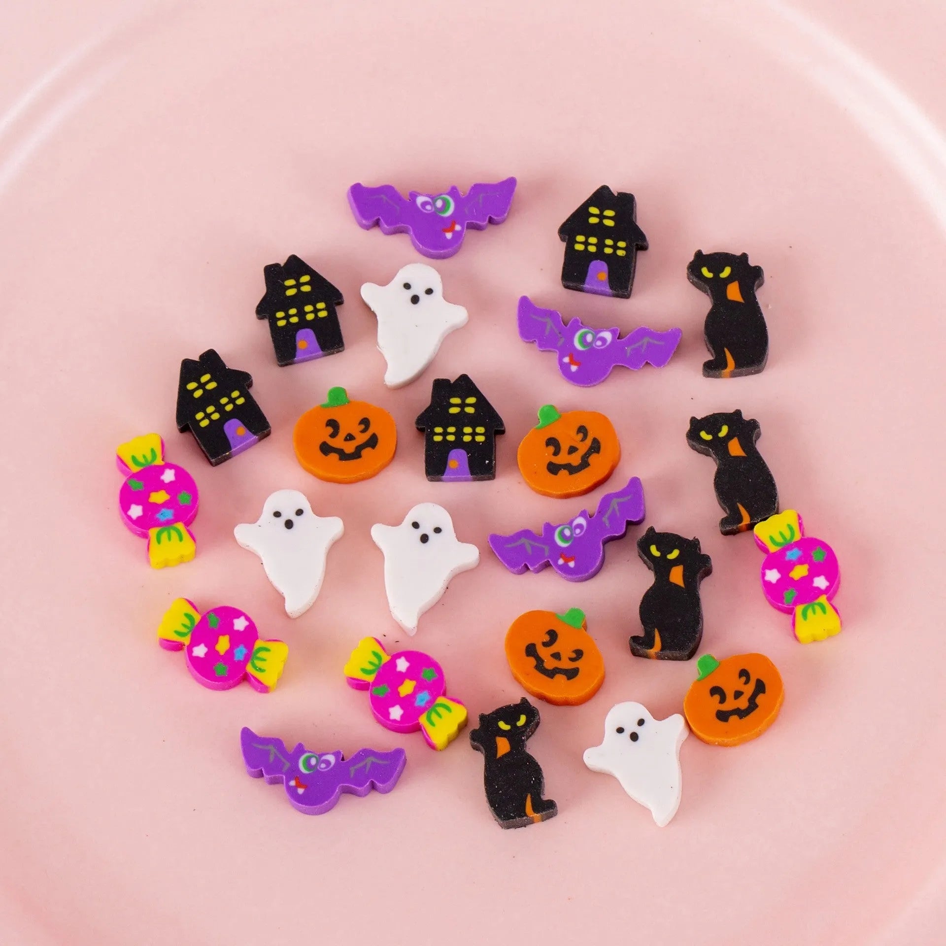 Sealed plastic bag containing 50 small cartoon-themed erasers in shapes like fruits, animals, and Christmas symbols.