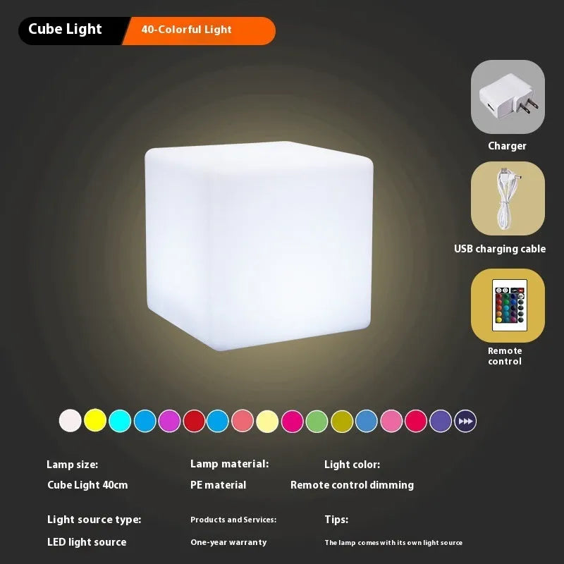 Modern square LED cube light stool in a garden setting, showcasing its clean design and luminous top.