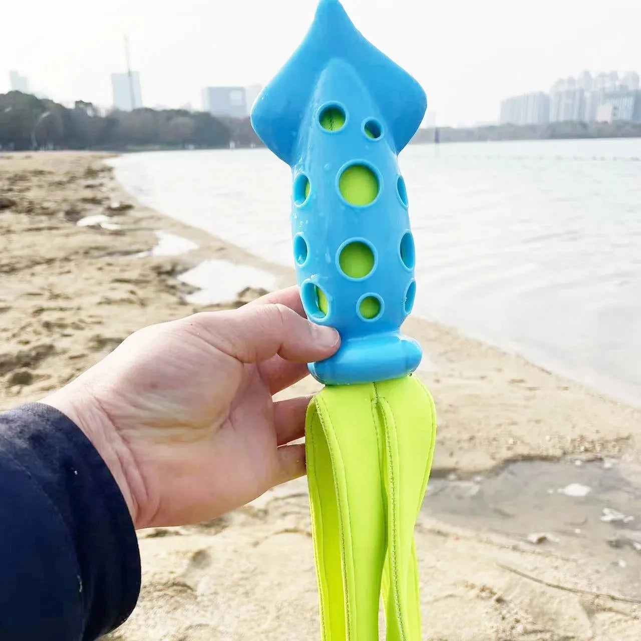 Blue cuttlefish-shaped dog chew toy with textured surface and squeaker for teeth cleaning