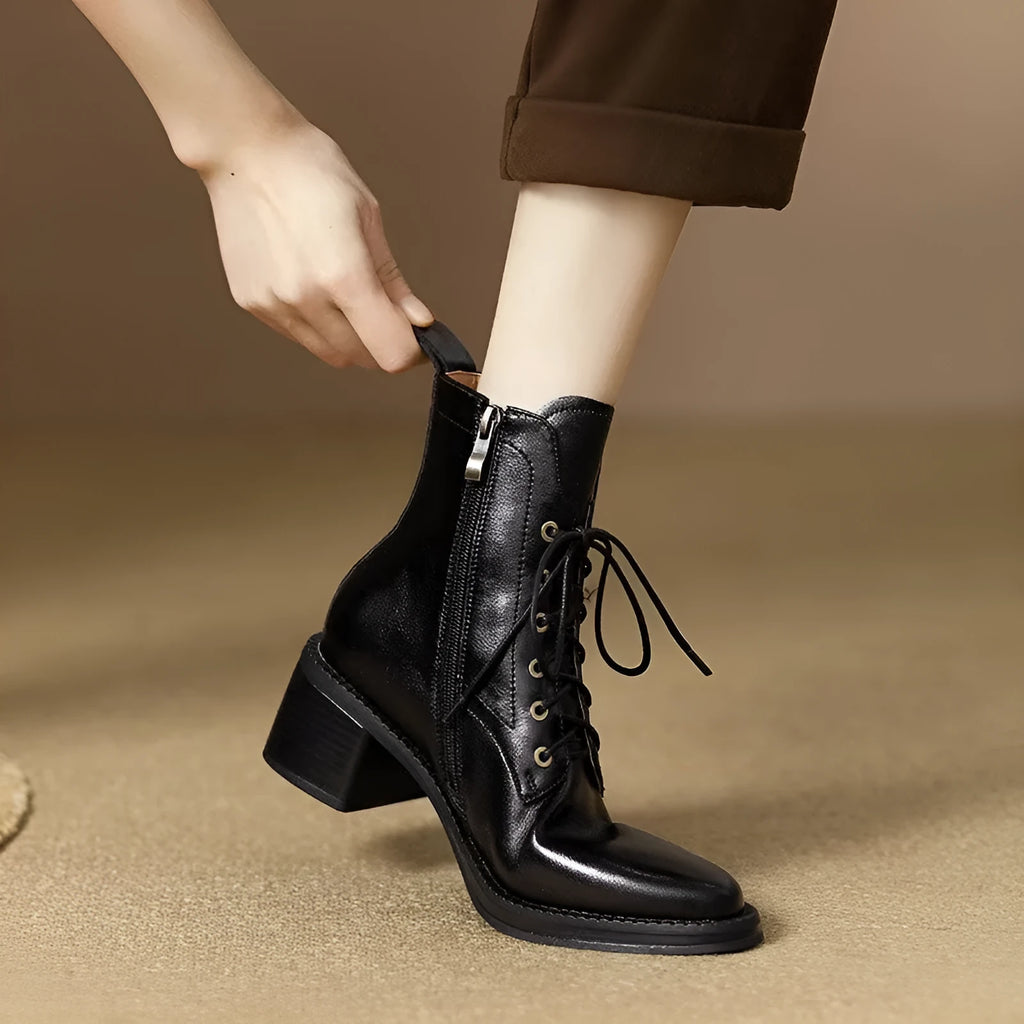 Women's black pointed-toe short boots with a 5.5cm heel and velvet finish on a neutral background.