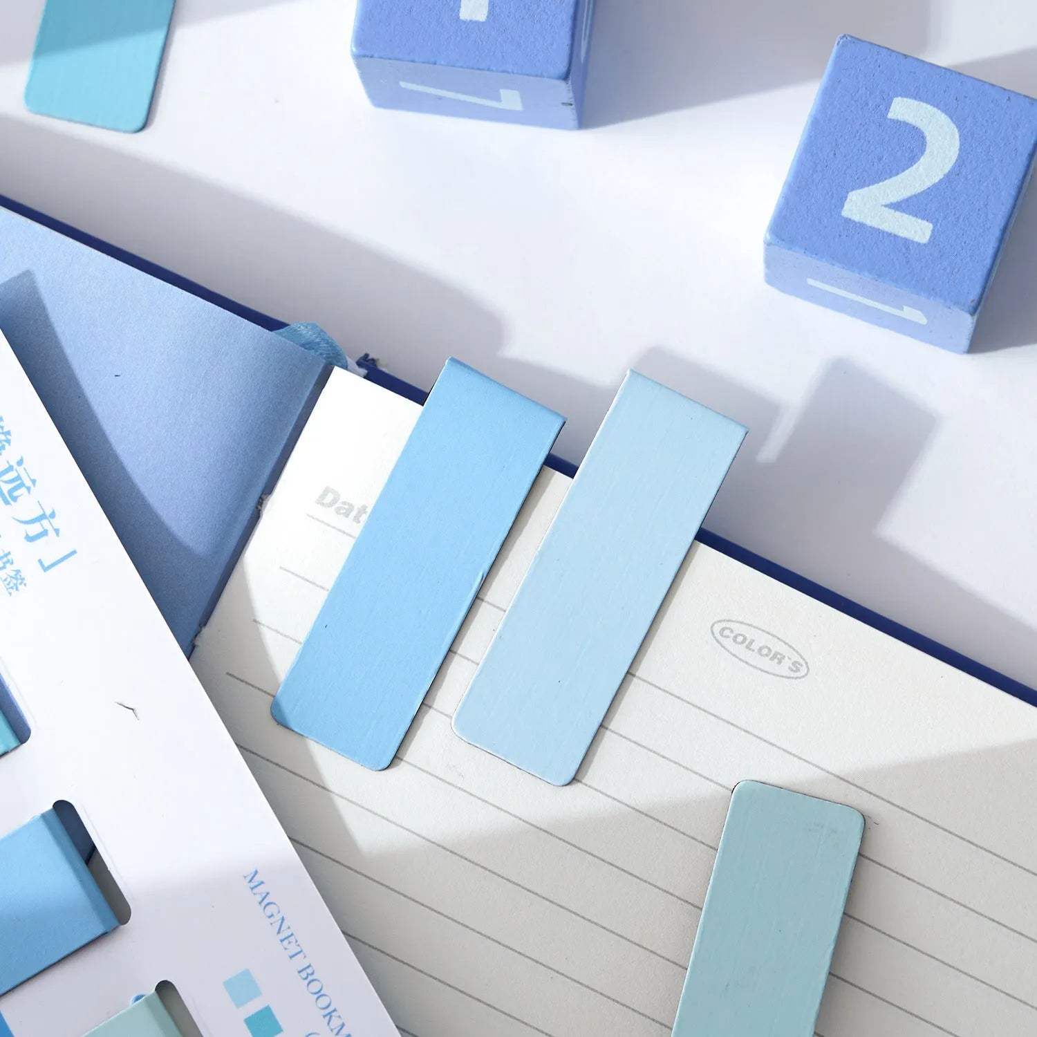 Set of four miniature magnetic bookmarks in soft Morandi series colour blocks on a white background.