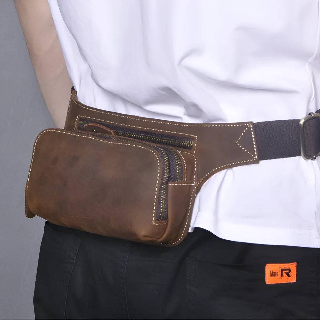 Brown top layer cowhide men's waist bag with pull cord closure, shown with phone compartment open.