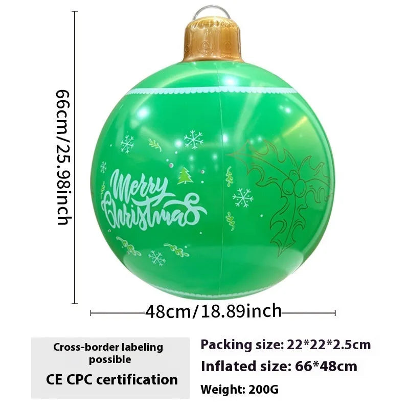 Large red and white inflatable Christmas ball with flashing lights in a garden setting