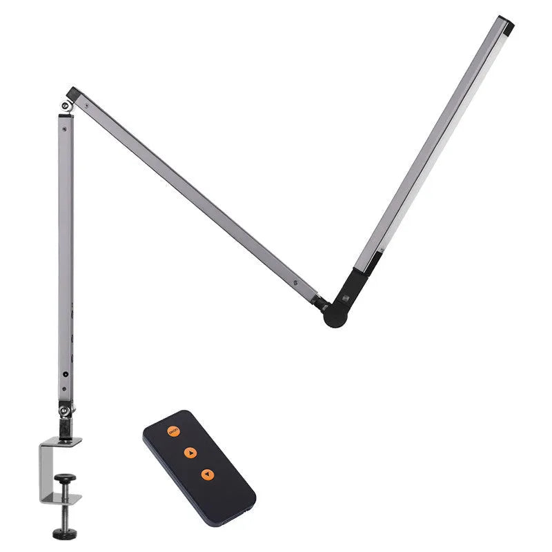 Adjustable LED desk lamp with clip attachment in black finish on wooden desk