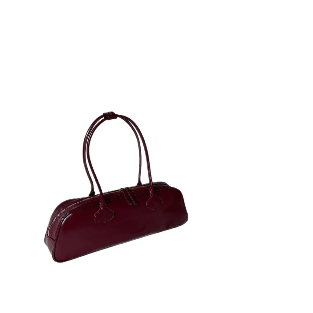 Women's solid colour genuine cowhide leather oval single-shoulder bag in brown with visible sewing thread detail.