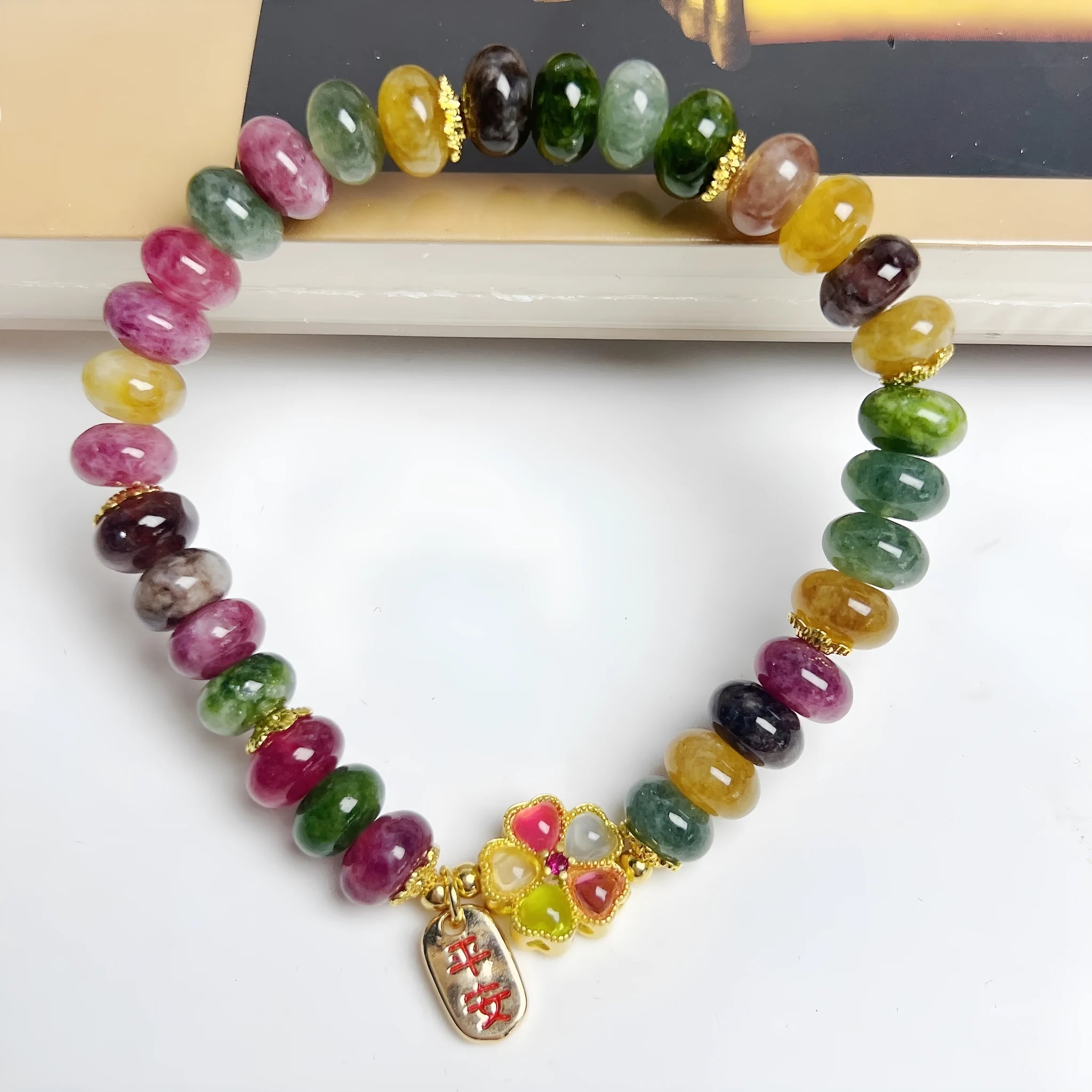 Colorful tourmaline abacus beads crystal stretch bracelet for women on a white background