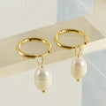 A pair of gold geometric earrings for women with pearl accents, made from stainless steel.