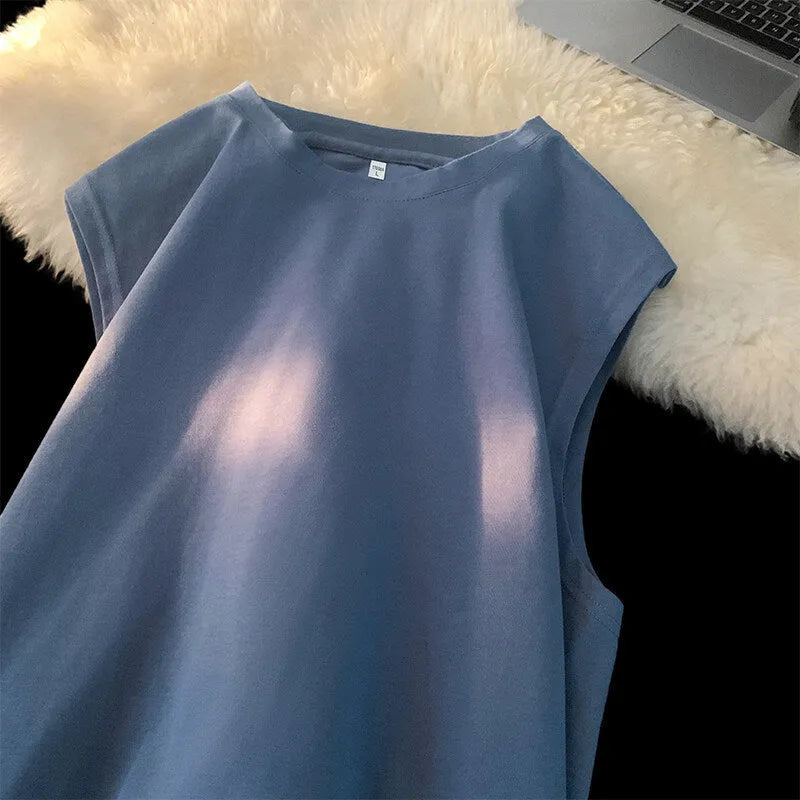 Men's loose solid colour cotton tank top on a hanger, showing straight hem and sleeveless design.