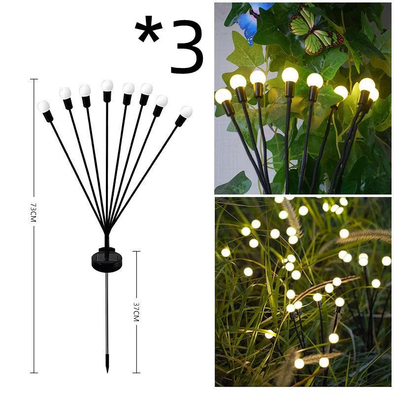 Solar-powered LED firefly garden spike light with multiple heads and a press-in ground plug on grass.