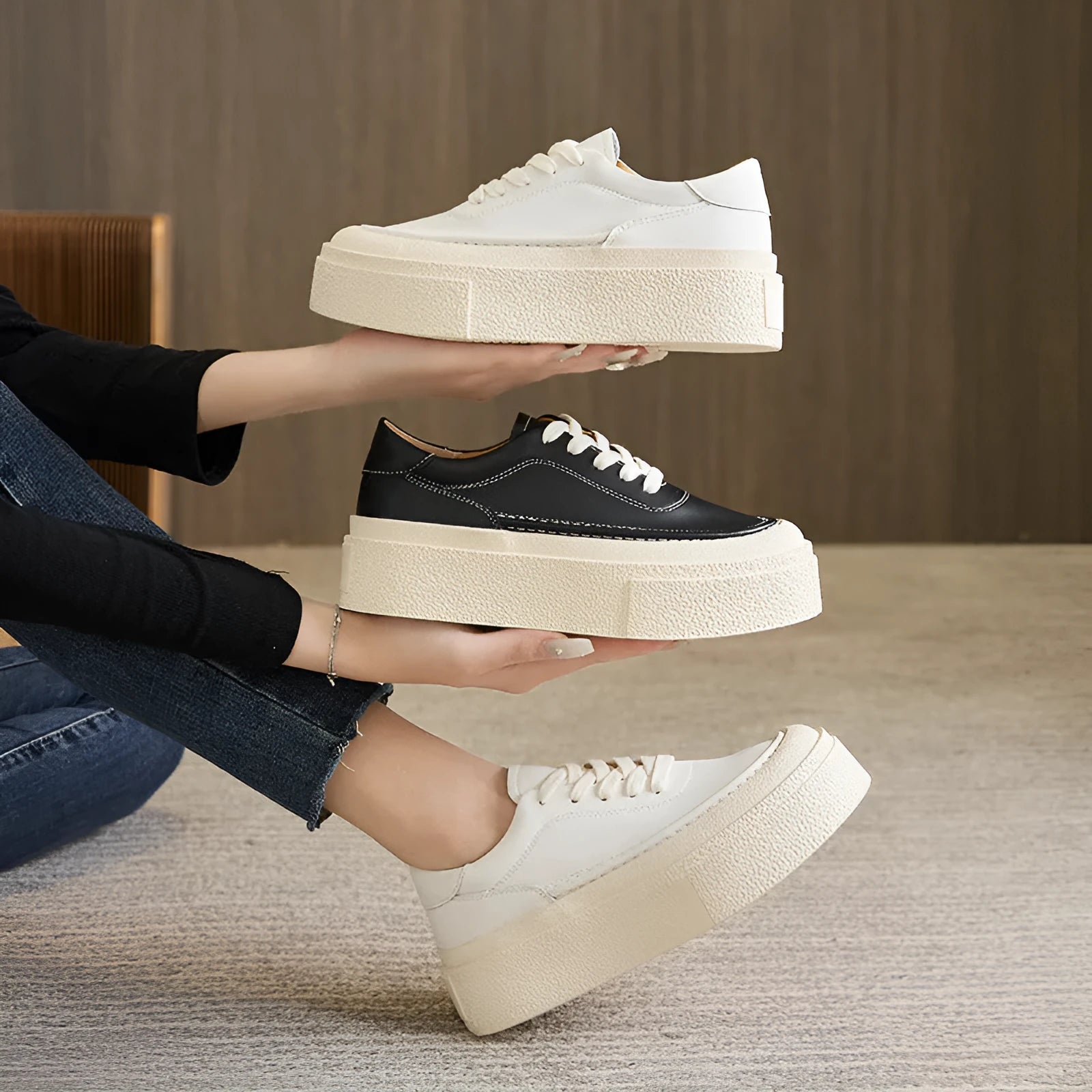 Women's black platform trainers with embossed leather upper and rubber sole
