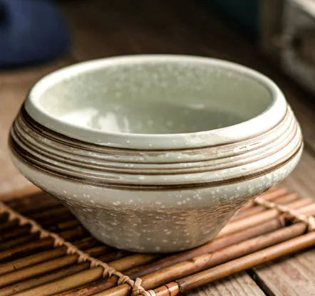 Tall porcelain ceramic Japanese soup bowl with underglaze vintage pattern on wooden table.