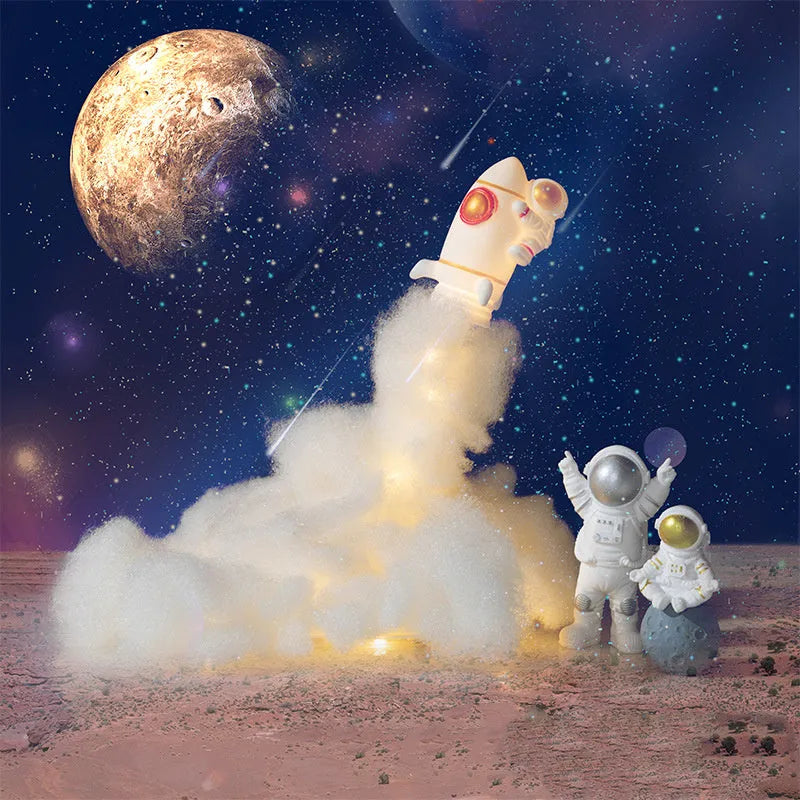 DIY astronaut rocket night light kit components including rocket model, LED lights, straws, and chassis on a desk.