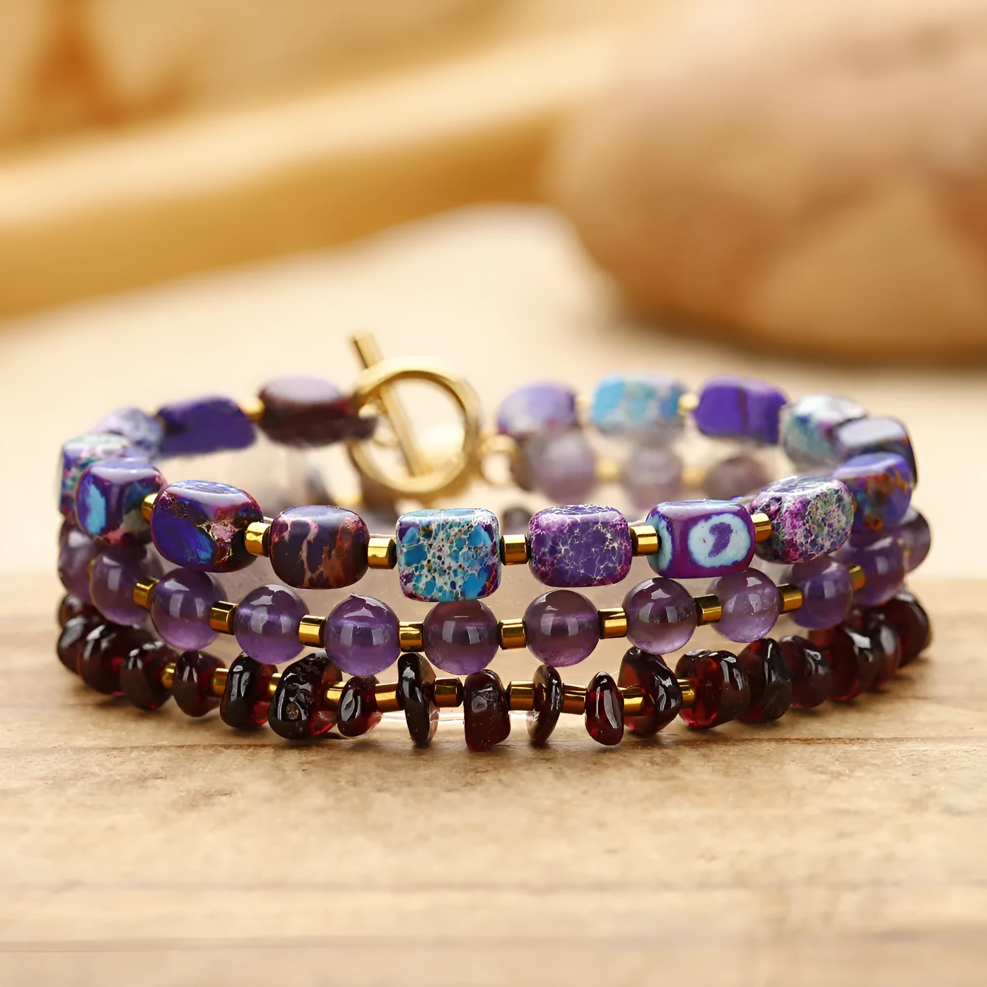 Purple amethyst and garnet stone bracelet with geometric beads and texture details