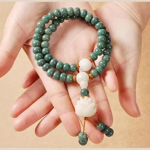 White jade green Bodhi seed bracelet with a safety buckle and lotus charm.