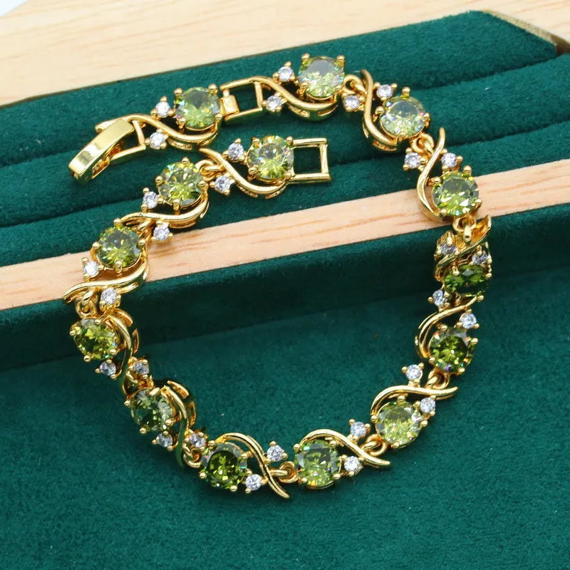 Olive green women's rhinestone jewellery suit with snake bones chain necklace, earrings, and ring on copper.