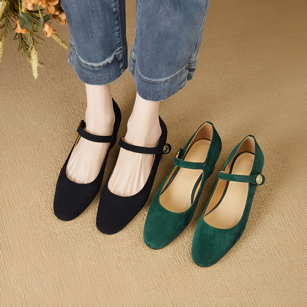 Women's black suede Mary Jane pumps with a chunky heel and square toe on a white background.