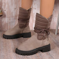 Women's black chunky heel snow boots with lace-up design and fleece lining on a high-top suede upper.