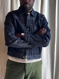 Dark blue denim button-up jacket with classic collar on a standard hanger