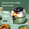 White air fryer oven with clear viewing window on door and mechanical dial controls on front.