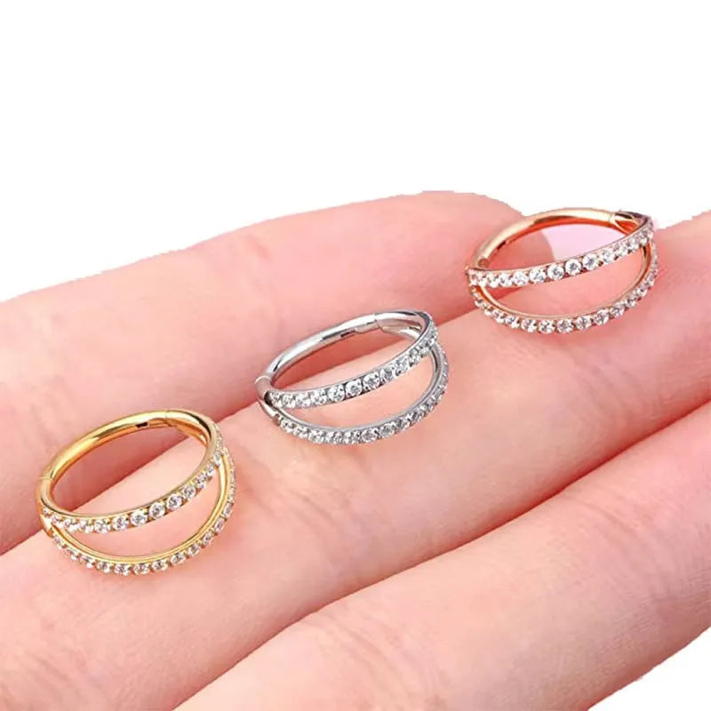 G23 titanium alloy puncture-style nose ring on a plain background showing steel and gold colour options.