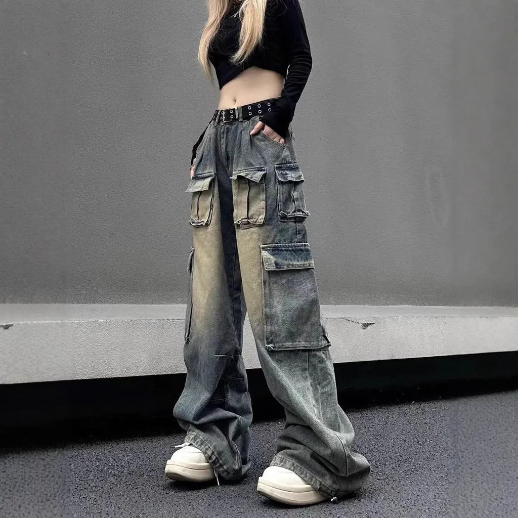 Man wearing loose light blue distressed jeans with multiple pockets, showcasing the straight-leg and utility style.