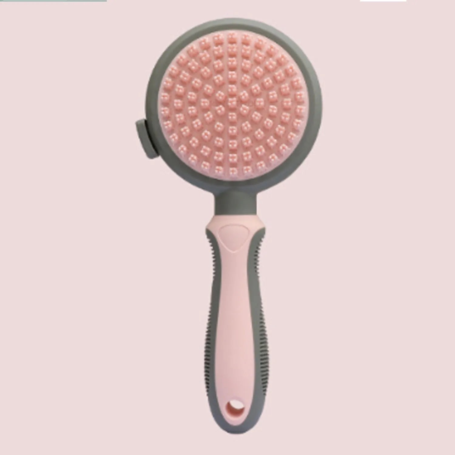 Green and pink double sided cat brush with release button showing brush and flea comb sides