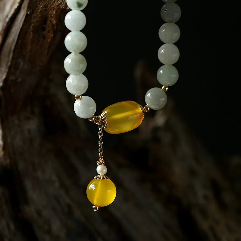 Women's ethnic geometric bracelet with hanging red agate beads and 14K gilded finish