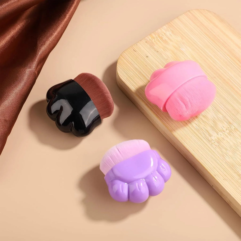 Three pet paw-shaped balm brushes with soft fibre heads in storage boxes