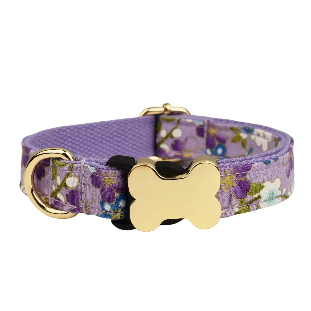 Flat nylon dog collar with printed grid pattern and white bone-shaped plastic buckle on a blue background.