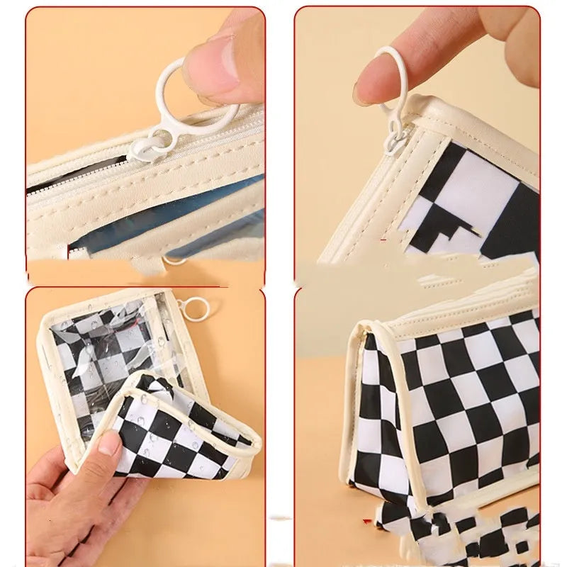 Clear PVC pencil case with black and white chessboard grid design, showing pens inside.