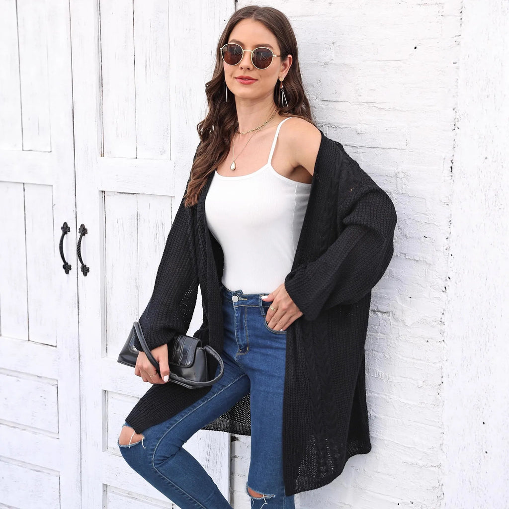 Women's loose acrylic sweater coat in a solid colour, shown in a casual style.