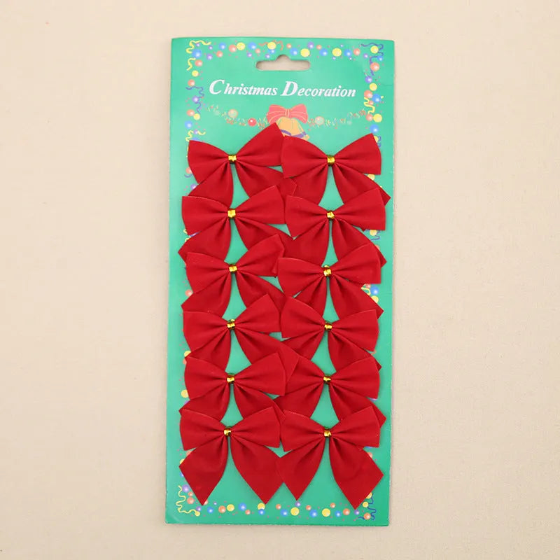 Red, gold, red gold, and silver 5 cm polyester Christmas bow ornaments on a green tree branch.