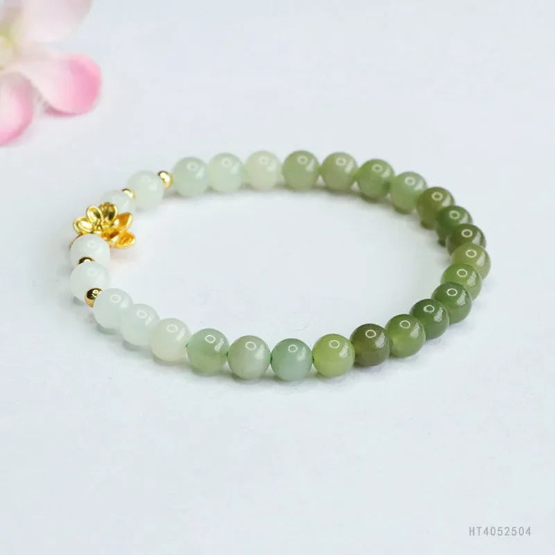 Hand-woven Chinese jade bracelet with water-gradient colour pattern and flower design