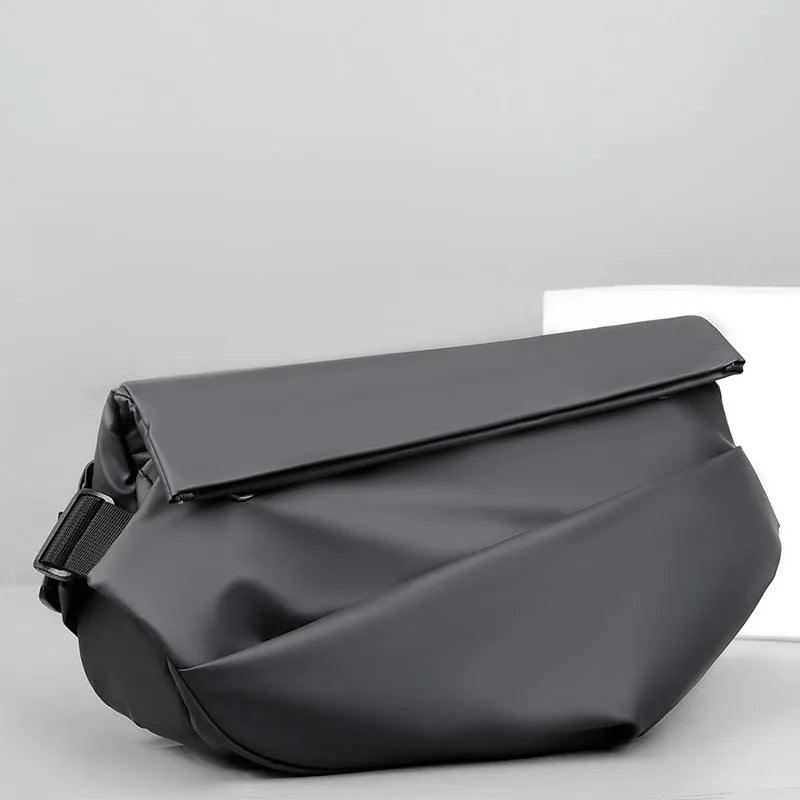 Grey PU leather men's crossbody sling backpack showing front zipper and shoulder strap.