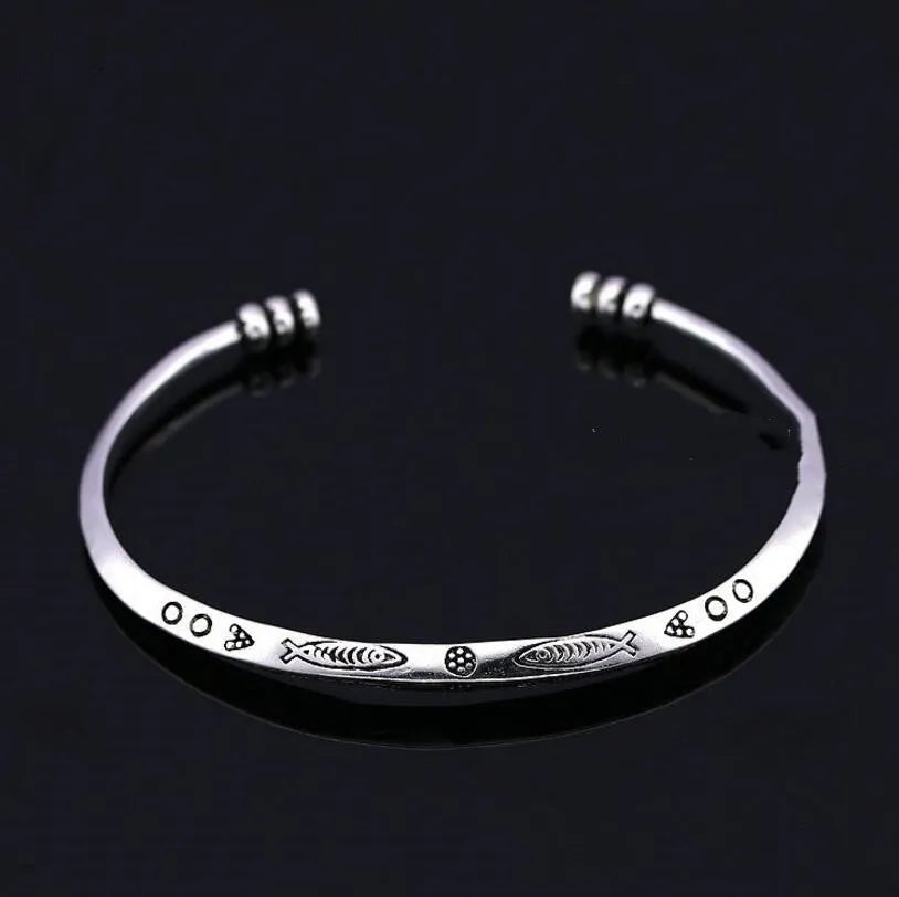 Women's silver-toned bracelet with Chinese retro fish design and magnetic clasp.