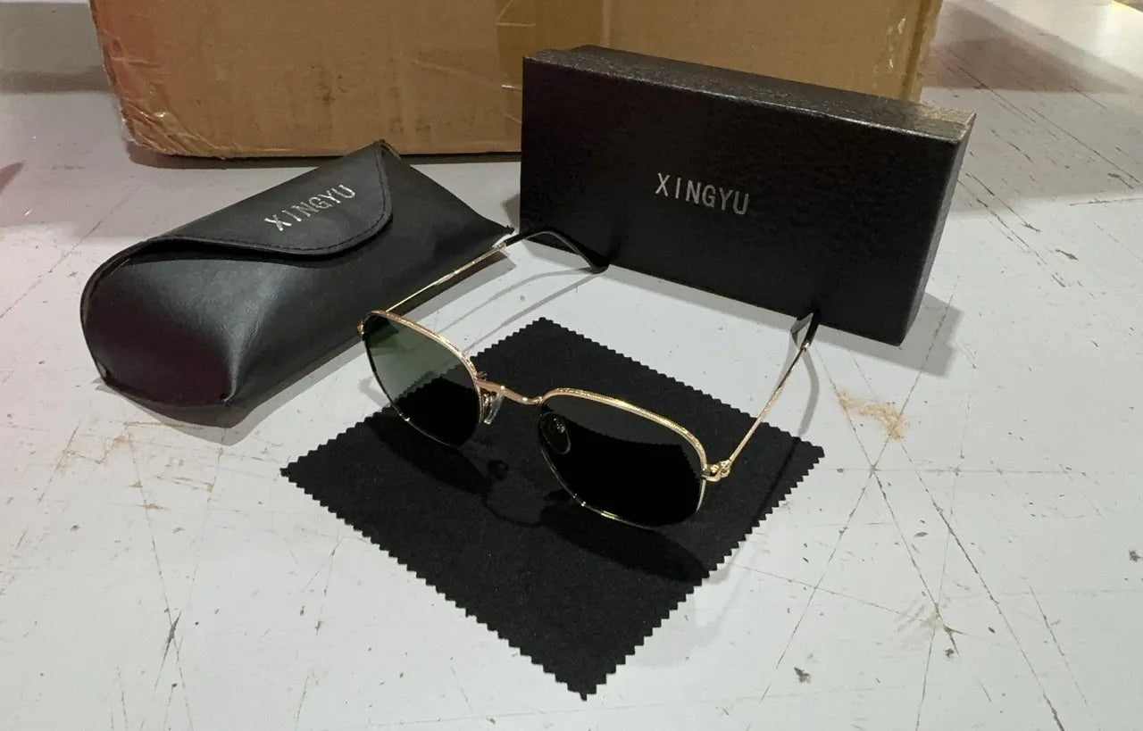 Classic round retro sunglasses for men in gun grey finish with UV400 lenses on a wooden table.