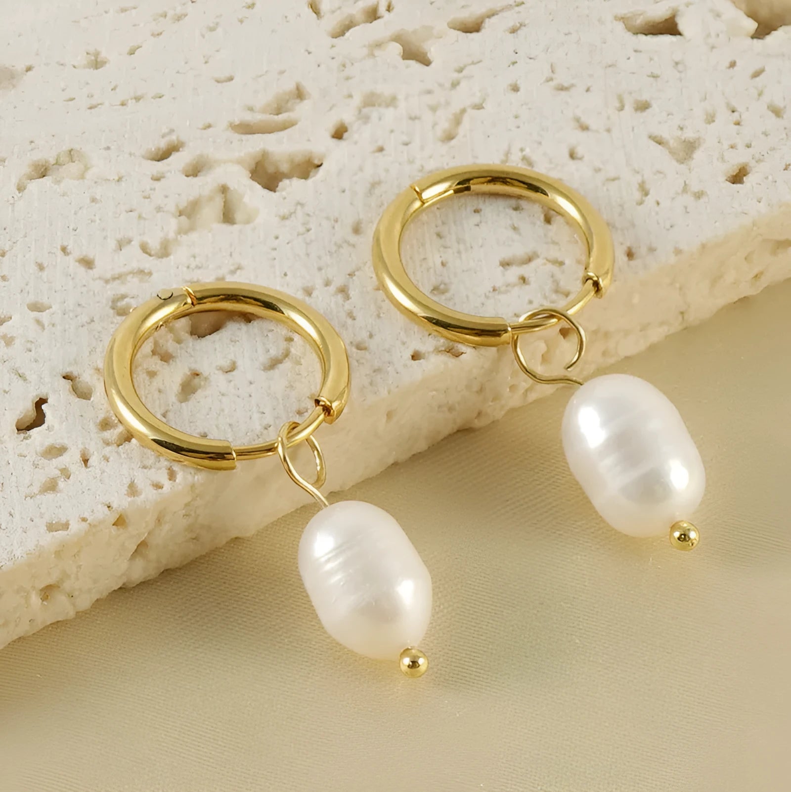 A pair of gold geometric earrings for women with pearl accents, made from stainless steel.
