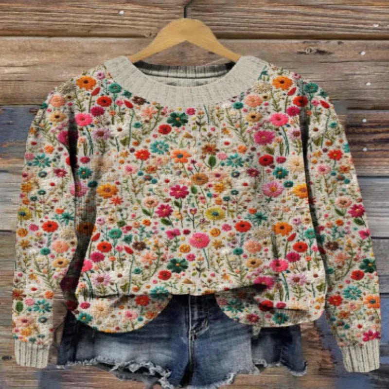 Women's little flower digital printed round neck long sleeve knitted sweater on a hanger.