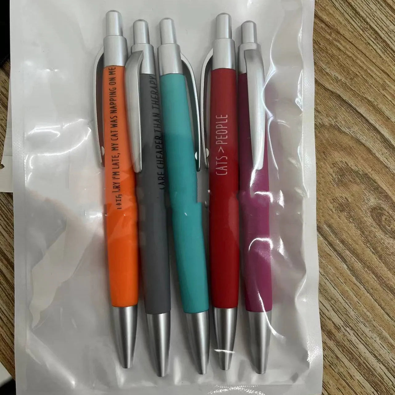 Set of five automatic pen markers with cat and dog themes in a beaded storage bag