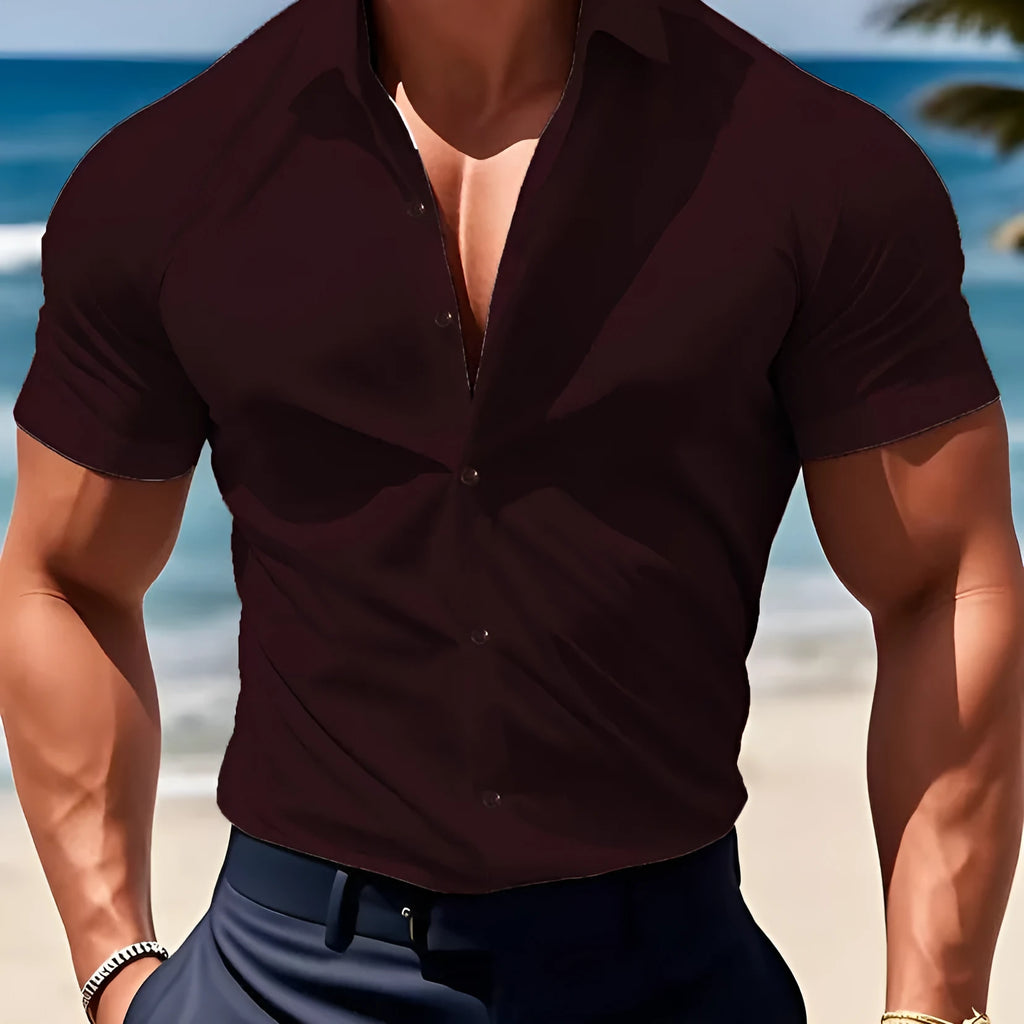 Man wearing a brown short sleeve printed casual shirt with a collar.