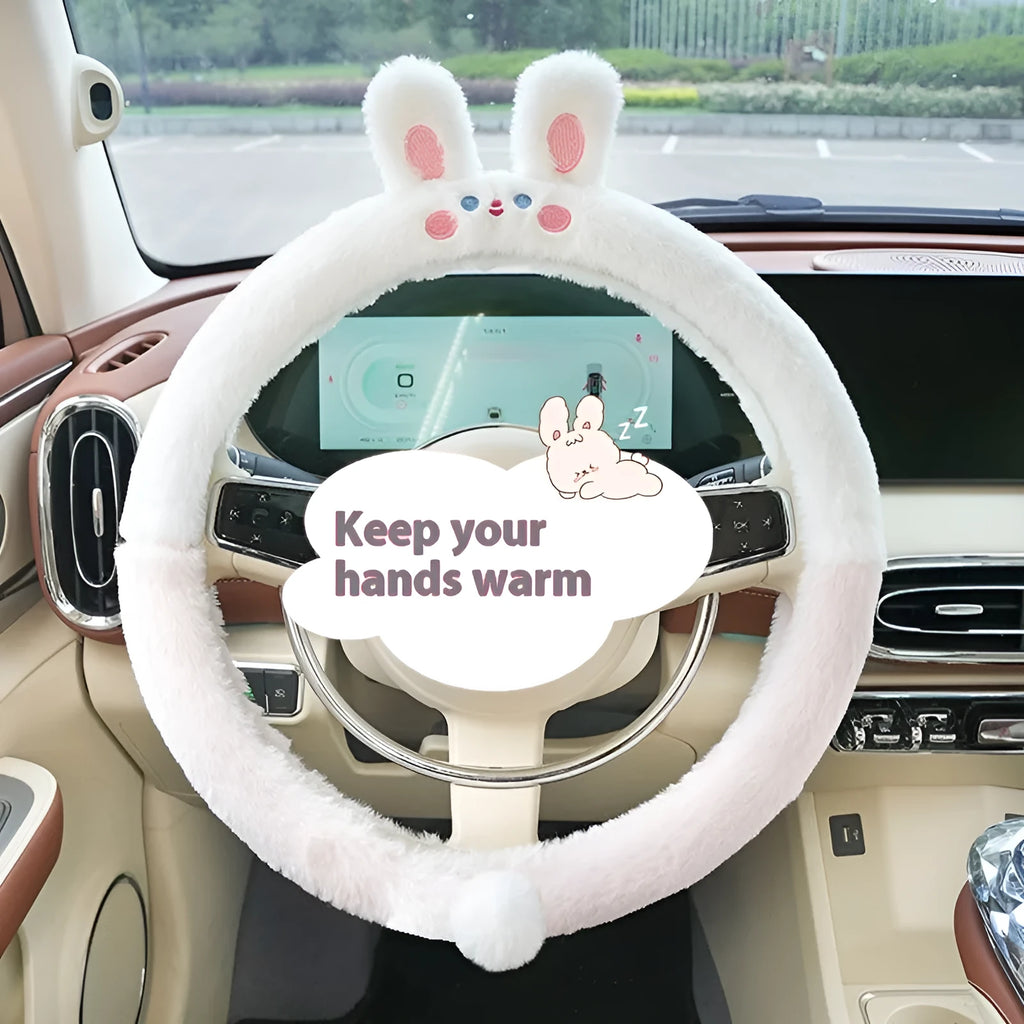 Plush steering wheel cover with embroidered bear design, shown fitted on a car steering wheel.