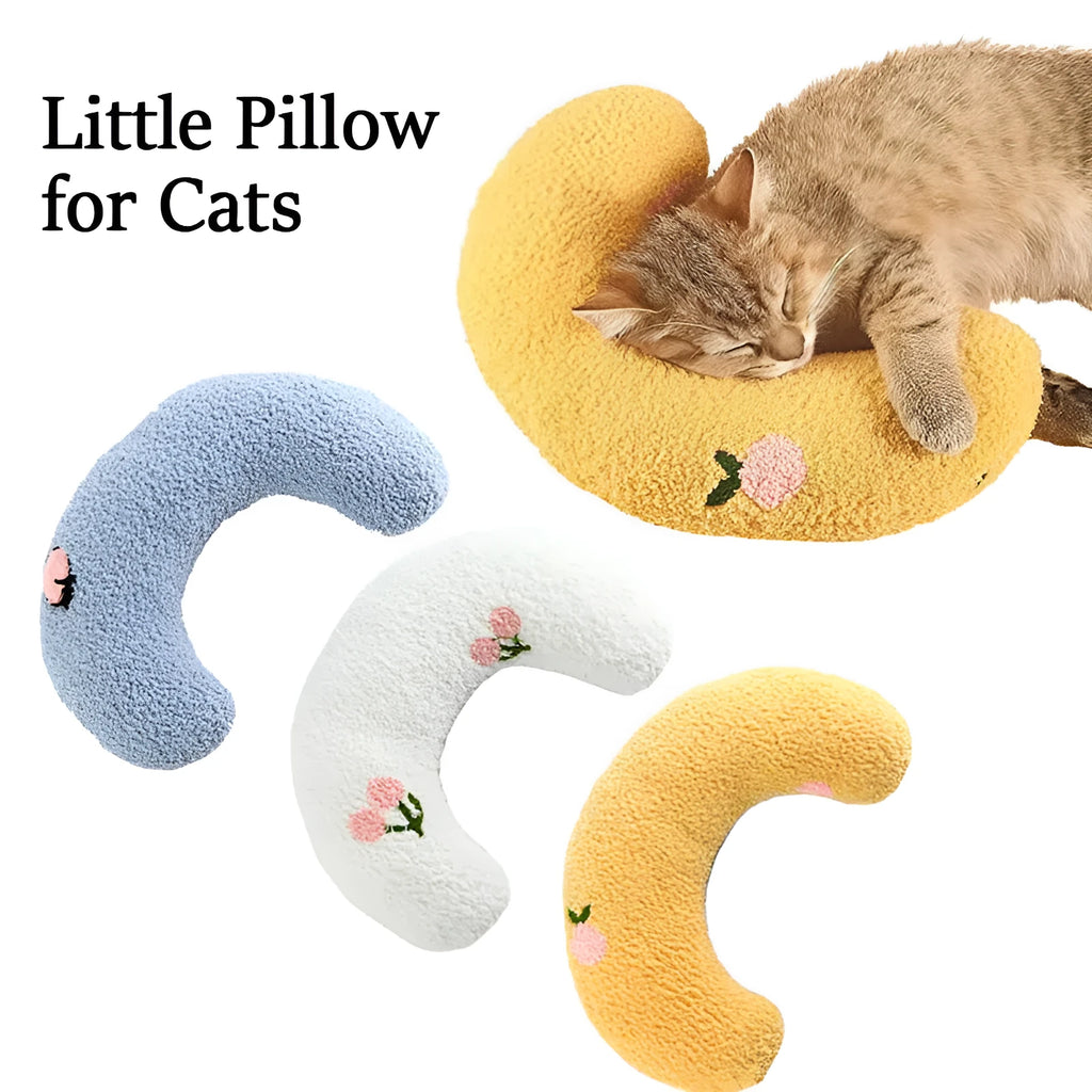 White U-shaped plush pet pillow for a small cat or dog on a grey background.