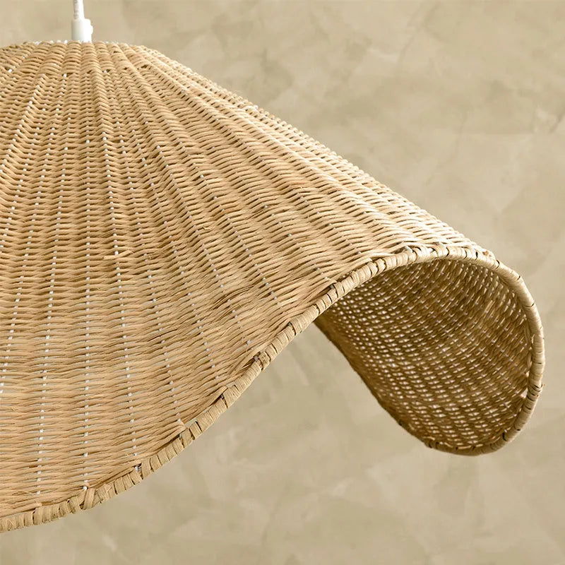 Handmade bamboo rattan chandelier with woven straw and willow lampshade in warm light