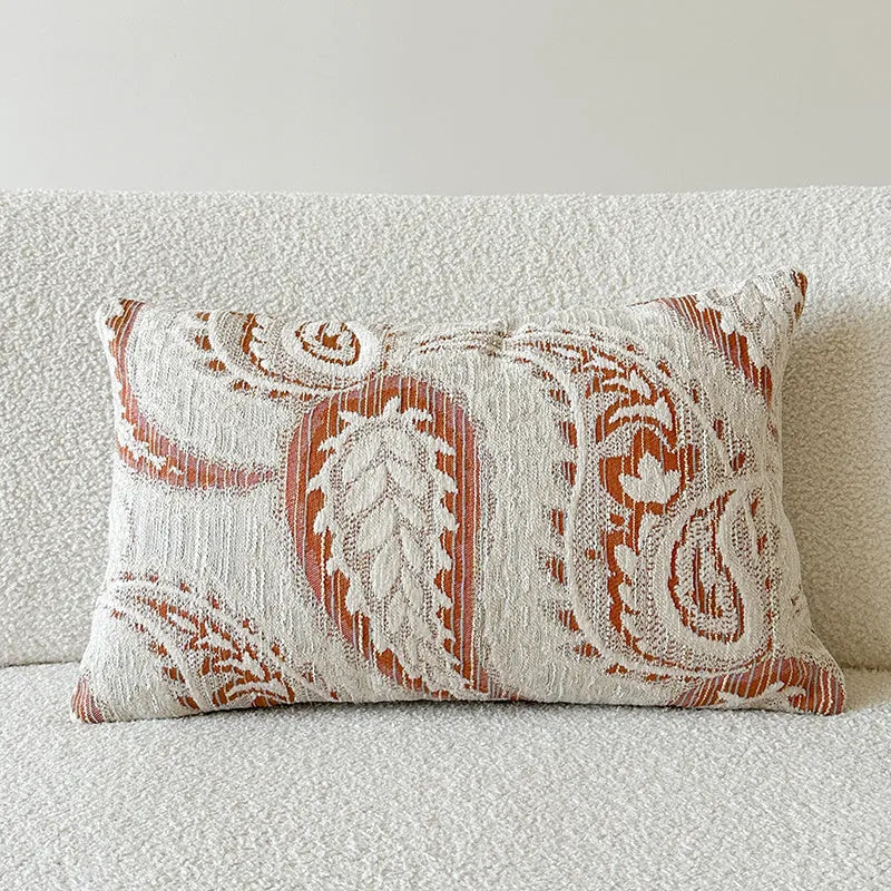 Amber American-style jacquard pillow cover with paisley and flower pattern on a sofa.