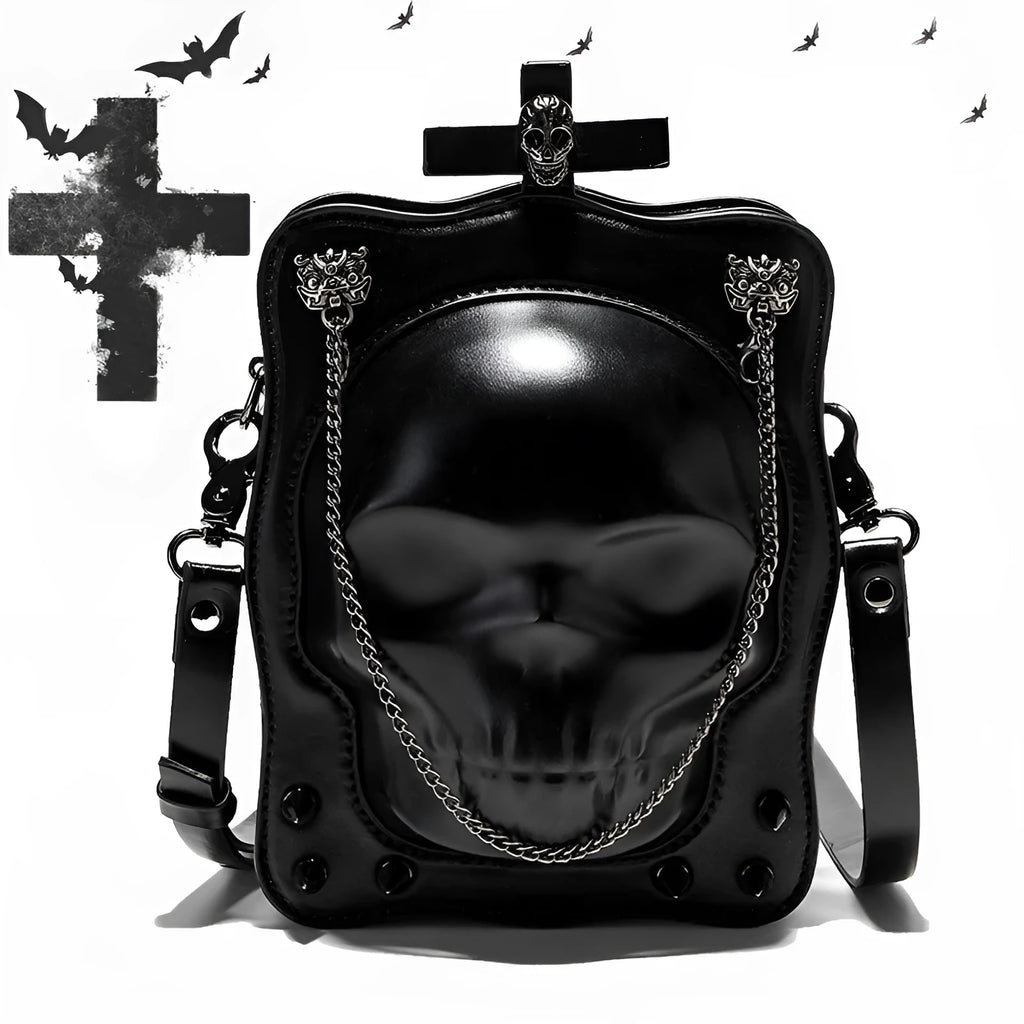 Black mini square crossbody bag with embossed skull design, metal chain strap, and zip opening.