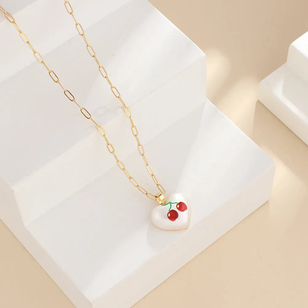 Heart-shaped necklace with fruit pendant on geometric chain showing strawberry pineapple apple pear cherry options
