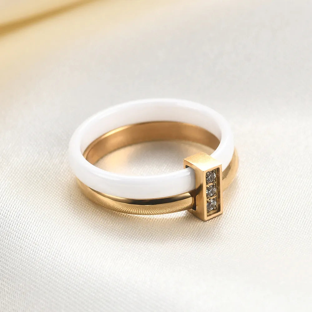 Glossy stitch and zirconium inlay ceramic ring for women in gold white on a geometric band.
